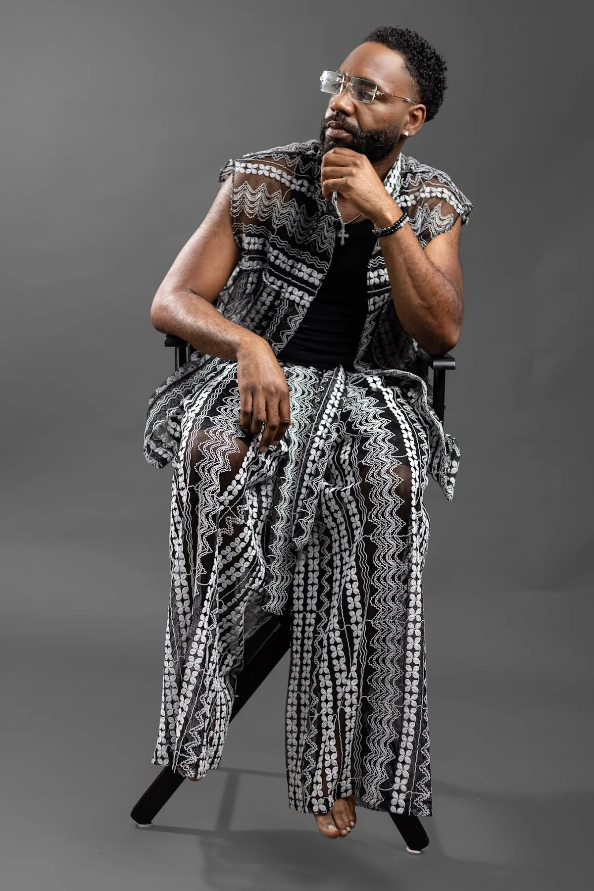 Designer in the monochrome patterned set, studio portrait.
